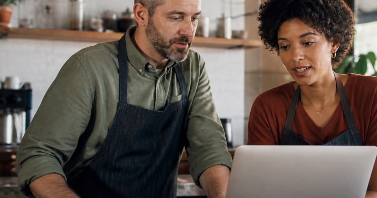 Small business team reviewing a job advertisement on a laptop